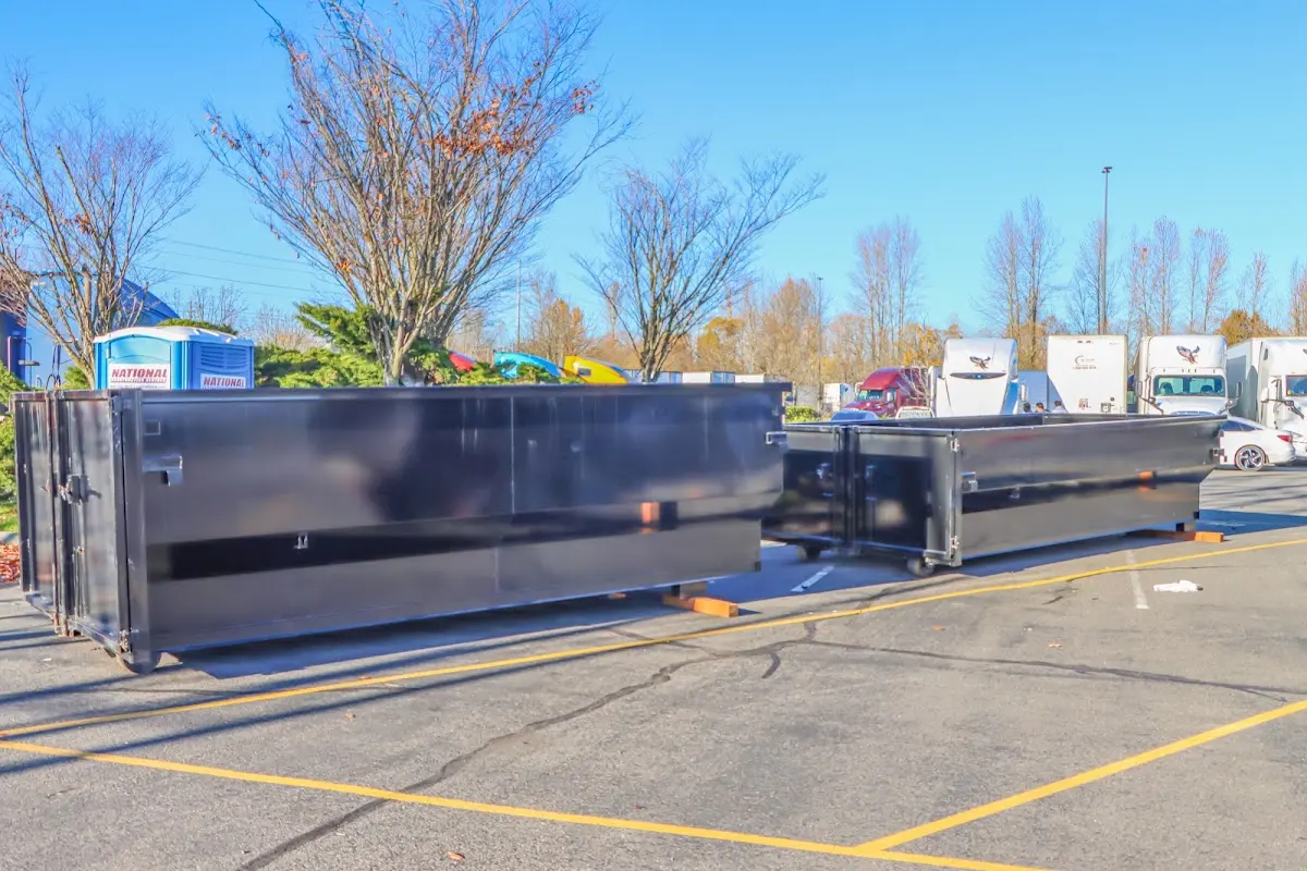 Professional dumpster rental service with roll-off container on residential driveway in Benton